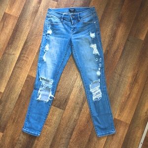 Bebe size 25 medium light wash destructed skinny jeans.